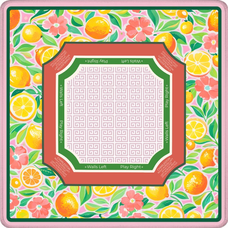 May include: A square, floral-patterned mat with a pink border. The design features lemons, pink flowers, and green leaves. A central, geometric design is framed by a red border with text that reads "Play Right" and "Walls Left".