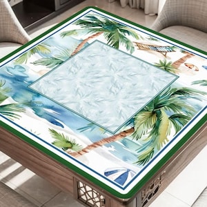 May include: A square table with a tropical beach scene printed on the surface. The design features palm trees, a beach, and ocean waves in shades of green, blue, and brown. The table has a green border and a wooden frame.