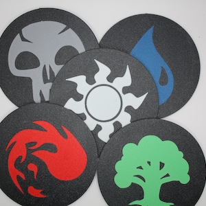 May include: Five round black coasters with different colored symbols. The symbols are a skull, a teardrop, a sun, a flame, and a tree.