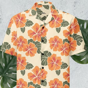 May include: A short-sleeved button-down shirt with a cream background and a repeating pattern of orange hibiscus flowers and green leaves.