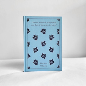 May include: A light blue book with a quote from Homer's Odyssey on the cover. The quote reads "There is a time for many words, and there is also a time for sleep." The cover is decorated with a repeating pattern of black and white amphorae.