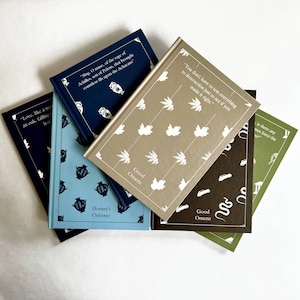 May include: Five hardcover books stacked on top of each other. The books are all different colors and have different patterns on the covers. The top book is a light brown color with a white pattern of plants. The second book is a dark brown color with a white pattern of snakes. The third book is a light green color with a white pattern of buildings. The fourth book is a light blue color with a dark blue pattern of urns. The fifth book is a dark blue color with a white pattern of urns. The text on the covers of the books includes quotes and titles such as "Good Omens", "Homer's Odyssey", and "Love, like a man, falling from an oak, tearing leaves from the branches".