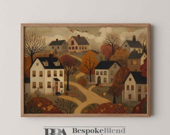 Puede incluir: Una impresión enmarcada de una escena de pueblo en otoño. La obra de arte representa varias casas con tejados negros y ventanas iluminadas, rodeadas de árboles con hojas naranjas y rojas. La impresión está en un marco de madera.
