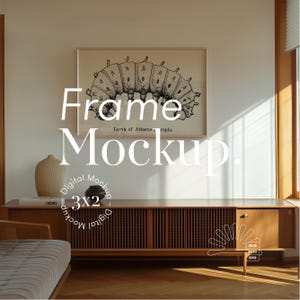 May include: A digital mockup of a 3x2 frame with a black and white illustration of a caterpillar inside. The frame is hanging on a beige wall with a wooden cabinet underneath. The text "Frame Mockup" is written in white letters on the wall.
