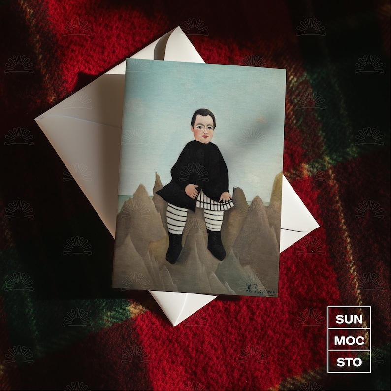 May include: A greeting card with a painting of a person in black clothing and striped trousers, set against a landscape. The card is accompanied by a white envelope, on a red and green plaid surface. The card has the text "SUN MOC STO" in the bottom right corner.
