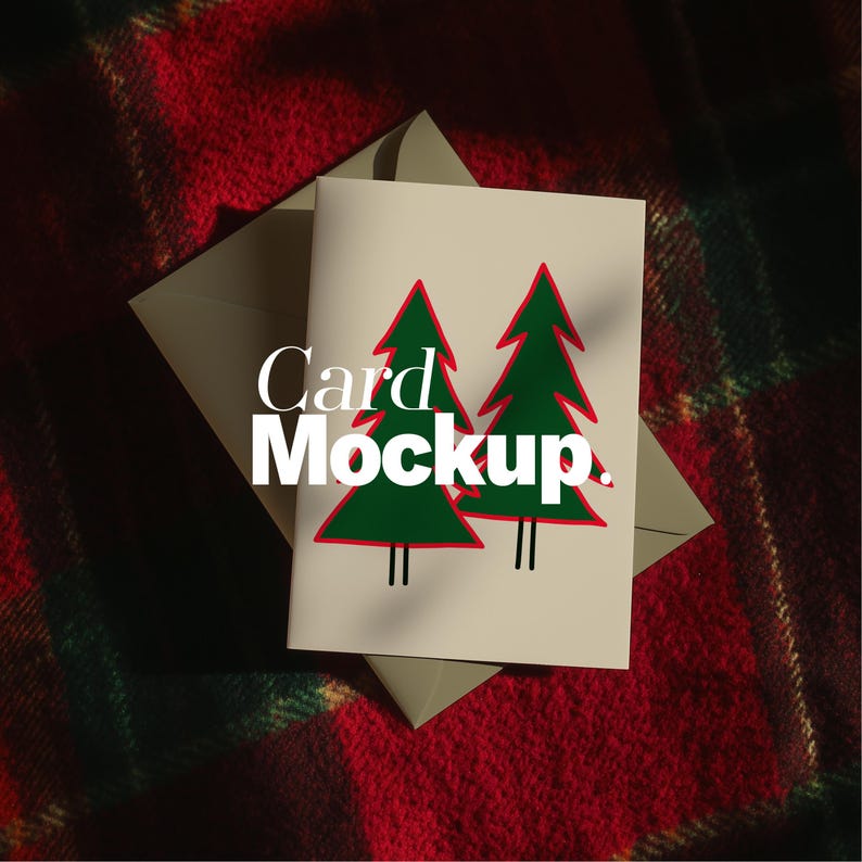 May include: A greeting card featuring two green Christmas trees with red outlines and black trunks. The card is inside a light grey envelope, set against a red and green plaid background. The words "Card Mockup" are printed on the card.