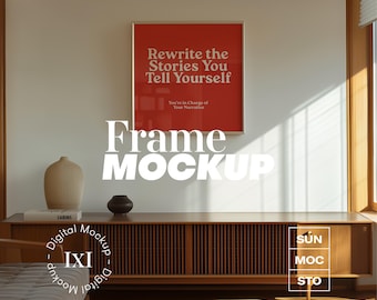 Peut inclure: Une maquette de cadre blanc avec un fond rouge et le texte "Rewrite the Stories You Tell Yourself" et "You're in Charge of Your Narrative". Le cadre est accroché à un mur blanc avec un meuble en bois et un vase au premier plan.