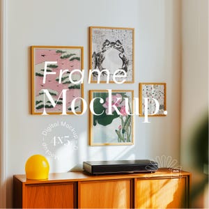 May include: A mockup of four framed prints on a white wall. The frames are all wooden and have a natural finish. The prints are all different and feature various subjects, including a frog, flowers, and clouds. The frames are arranged in a staggered pattern, with the largest frame at the top and the smallest frame at the bottom. The wall is painted white and there is a wooden cabinet with a yellow sphere on top of it.