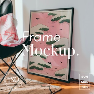 May include: A black picture frame with a pink and green print of clouds and birds. The frame is sitting on a wooden floor with a rug in front of it. The text "Frame Mockup." is written in white on the image.