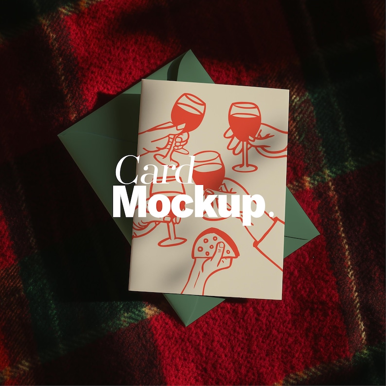 May include: A greeting card mockup featuring a red illustration of wine glasses and hands, with the text "Card Mockup." The card rests on a green envelope, against a red and green plaid background.