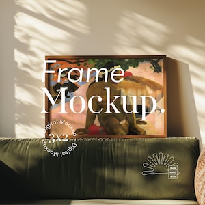 May include: A framed print of a painting depicting a woman with a flower crown sitting on a beach. The frame is brown wood and the painting is in a warm colour palette. The text "Frame Mockup" is superimposed on the image.