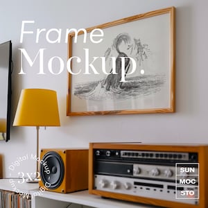 May include: A framed black and white illustration of a whale breaching the water, hanging on a white wall above a vintage stereo system with a yellow lamp on the left. The text "Frame Mockup" is written in white on the wall.