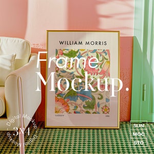 May include: A gold frame mockup with a floral print inside. The print is by William Morris and is titled "Lodden". The frame is sitting on a green and white checkered surface.