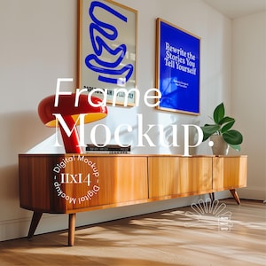 May include: A wooden cabinet with a mid-century modern design, featuring three doors and angled legs. A red mushroom lamp, books, and a plant are on top. Two framed posters are on the white wall. The image includes the text "Frame Mockup".