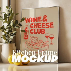 May include: A silver framed picture with a white background and red text that says "Wine & Cheese Club". The picture also includes a drawing of a bottle of wine, cheese, and two glasses of wine. The text "Kitchen Frame MOCKUP" is below the picture.