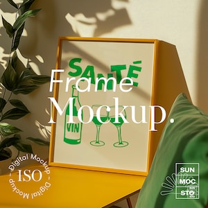 May include: A yellow frame mockup with a green graphic of a wine bottle and two wine glasses. The graphic says "Santé".