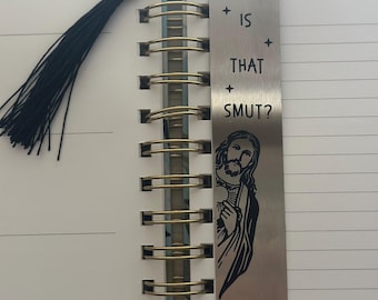 May include: A silver bookmark with a black and white image of Jesus and the text "Is that smut?"