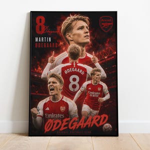 May include: A rectangular poster featuring Martin Ødegaard in an Arsenal kit. The design includes multiple images of the player, the number 8, the Arsenal crest, and the text Martin Ødegaard and Emirates Stadium against a dark red background.