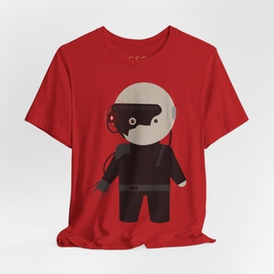 May include: Red t-shirt with a cartoon illustration of a robot wearing a helmet and a black jumpsuit.