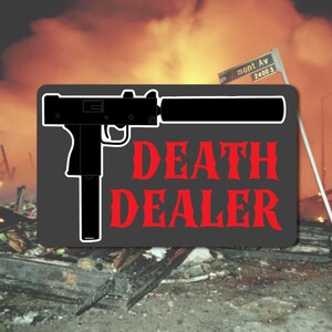May include: A black and white graphic of a gun with a silencer, set against a backdrop of a burning building and a street sign. The words "DEATH DEALER" are in red, bold font.