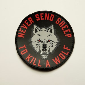May include: Black and red embroidered patch with a wolf's head and the text "Never send sheep to kill a wolf."