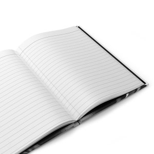 May include: A black and white notebook with lined pages, open to reveal the blank pages.