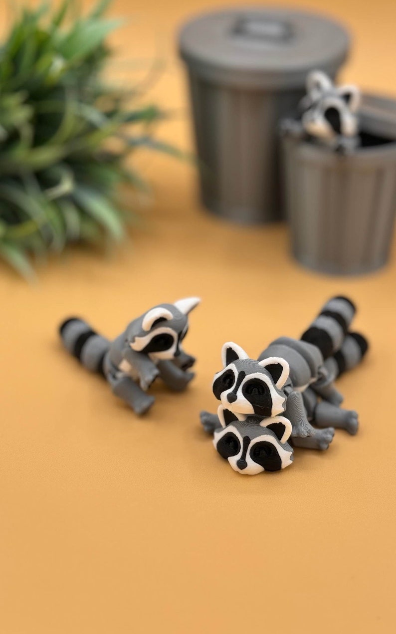 3D printed raccoon fidget toy and trash can storage container.