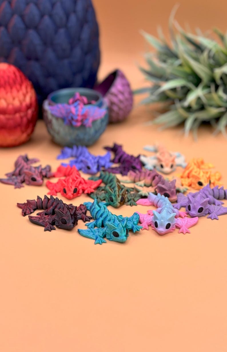 3D printed wyvern dragon toys come in a variety of colors including metallic red, teal, purple, gold, green, and more.