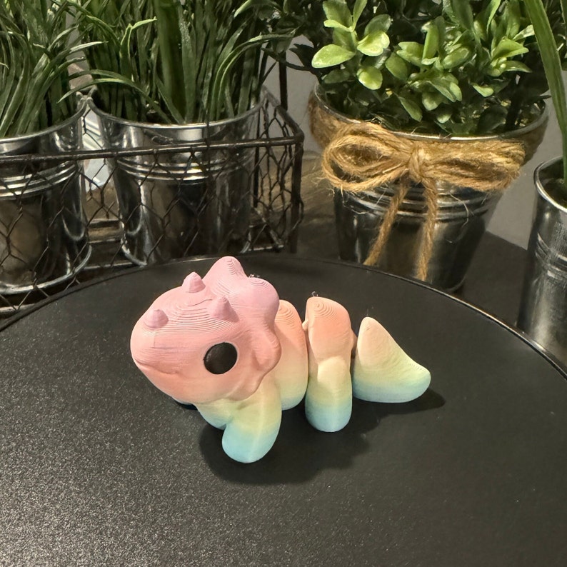 Example of a rainbow 3D printed triceratops.