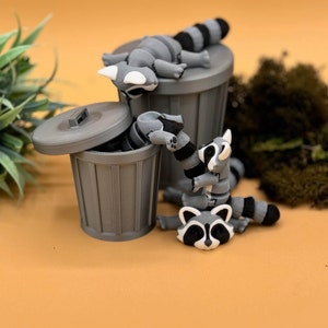 3D printed large and baby raccoon toys.