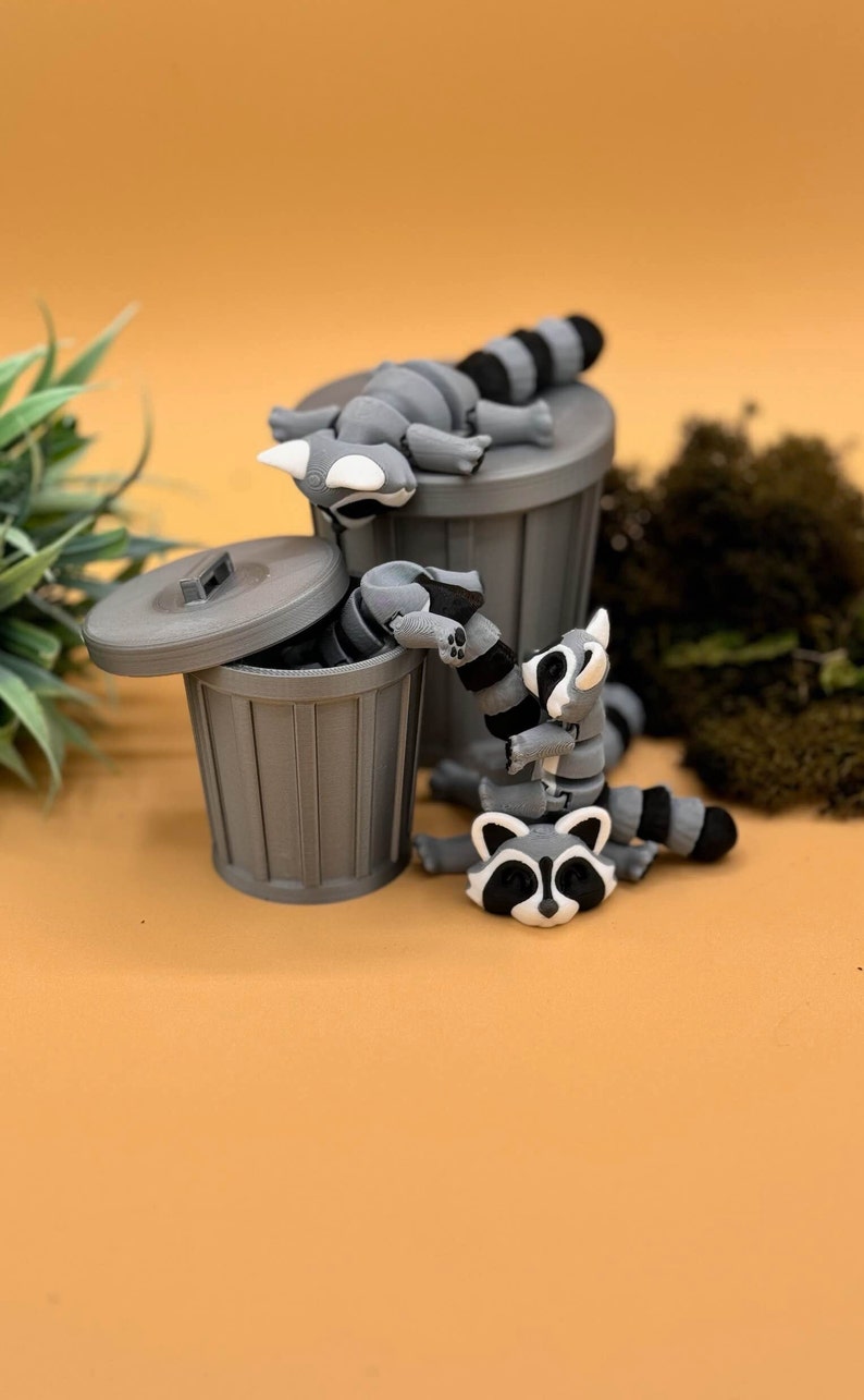3D printed large and baby raccoon toys.