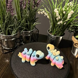 3D printed rainbow stegosaurus toys.