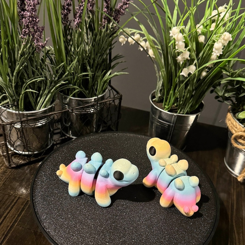 3D printed rainbow stegosaurus toys.