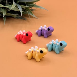 Stegosaurus sensory toys come in shades of purple, pink, mint green, and yellow.