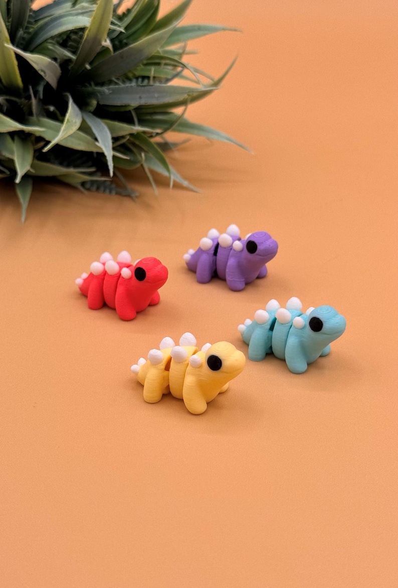 Stegosaurus sensory toys come in shades of purple, pink, mint green, and yellow.