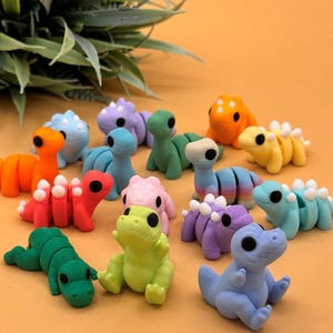 Assortment of 3D printed dinosaur toys make great gifts for Jurassic park fans, dinosaur lovers, and more.