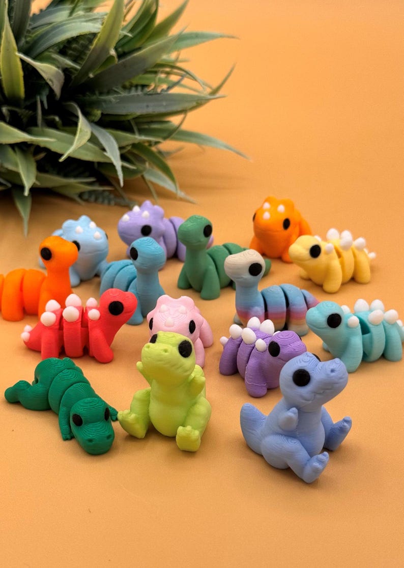 Assortment of 3D printed dinosaur toys make great gifts for Jurassic park fans, dinosaur lovers, and more.
