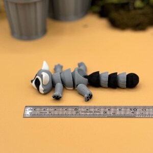3D printed raccoon toys are about 4 inches long.