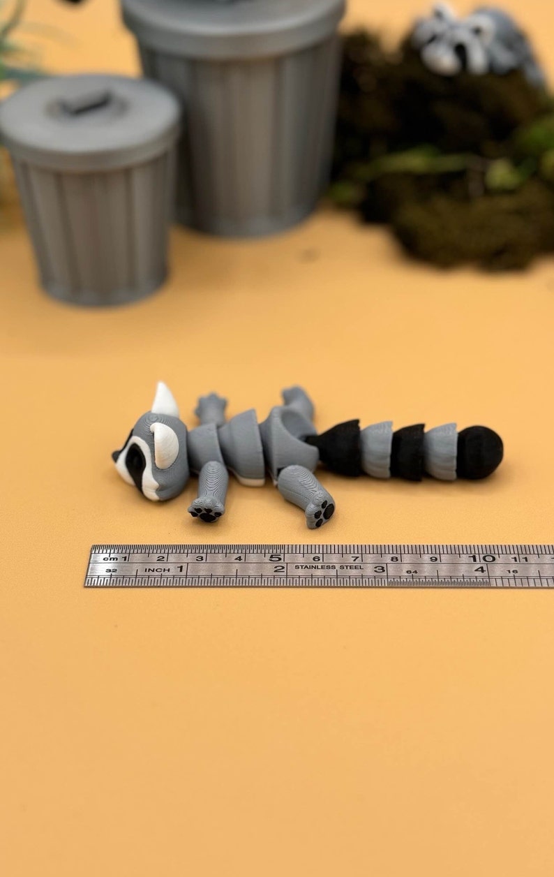 3D printed raccoon toys are about 4 inches long.