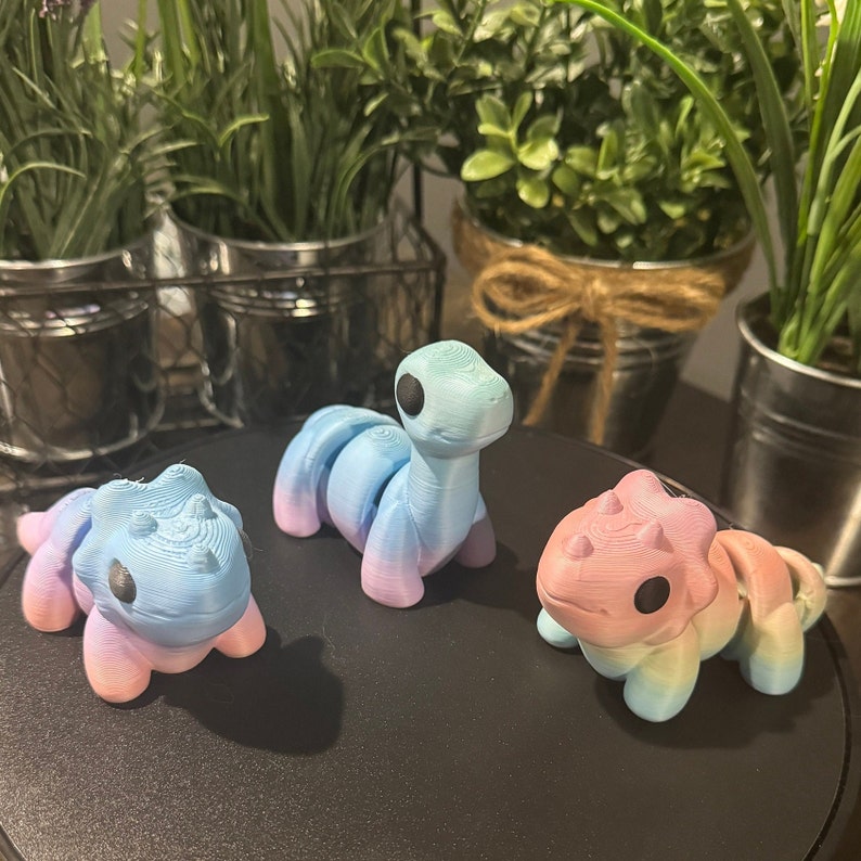 3D printed dinosaurs are made with rainbow PLA. This means each print is unique!