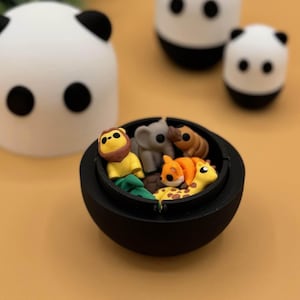 Adorable 3D printed fidget toys inside of a panda container.