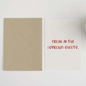 May include: A white card with red text that reads "Freak in the (spread) sheets."