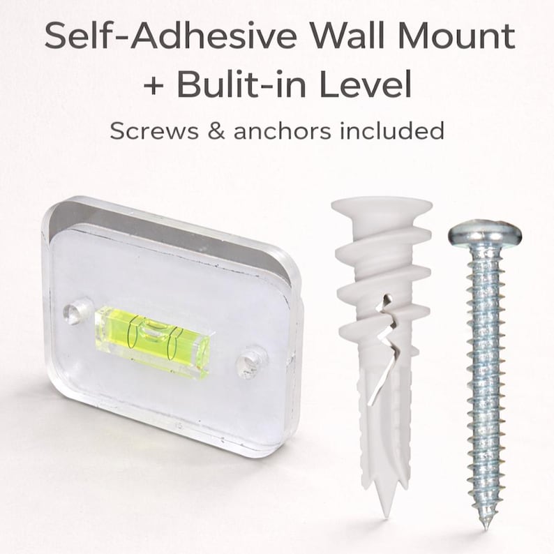 May include: A clear, rectangular self-adhesive wall mount with a built-in level, a white plastic wall anchor, and a silver screw. The text "Self-Adhesive Wall Mount + Built-in Level" is at the top of the image.