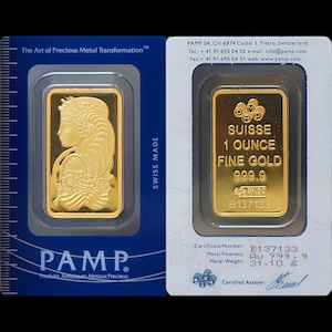 May include: A gold bar with the inscription "SUISSE 1 OUNCE FINE GOLD 999.9" and the serial number "B137133". The bar is in a clear plastic case with a white background and the words "SWISS MADE" printed on the side.