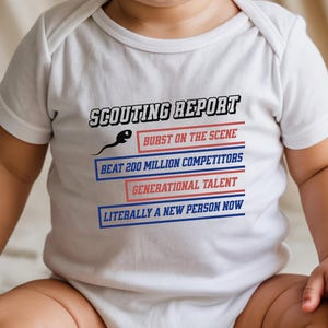May include: White baby onesie with the text "SCOUTING REPORT" and humorous phrases like "Burst on the Scene" and "Beat 200 Million Competitors." The onesie has a sperm graphic and is designed for infants.