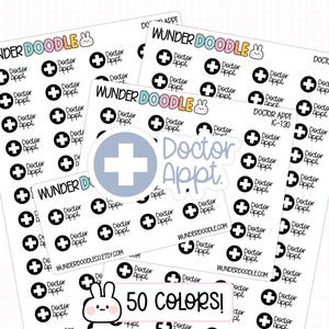 Op de afbeelding: Meerdere vellen witte plannerstickers met zwarte medische kruispictogrammen en de tekst "Doctor Appt.". De merknaam "WUNDER DOODLE" met een klein konijntjesicoon staat bovenaan gedrukt. Een grotere ronde sticker met een blauw kruis in het midden.