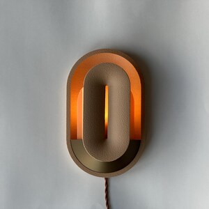 Plug in wall sconce turned on.