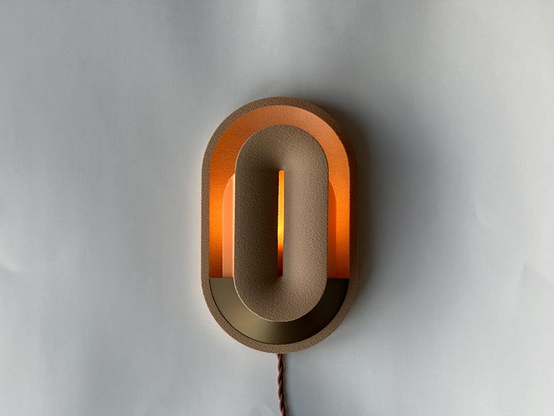 Plug in wall sconce turned on.