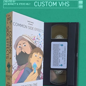 May include: A VHS tape with a custom label featuring the title "Common Side Effects" and the text "Season One". The label has a cartoon illustration of a man and a girl with a mushroom.