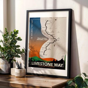 May include: A framed print depicting the Limestone Way in the Peak District National Park. The map shows the trail with a black line against a backdrop of blue, orange, and green gradients. The text "46 Miles / 74 KM" is displayed.